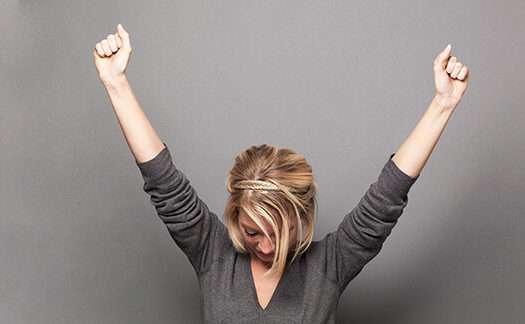 A woman celebrating after a successful music atudition.